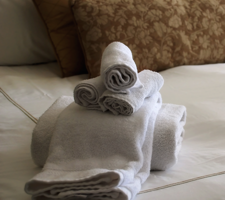 Motel Bed with Folded Towels